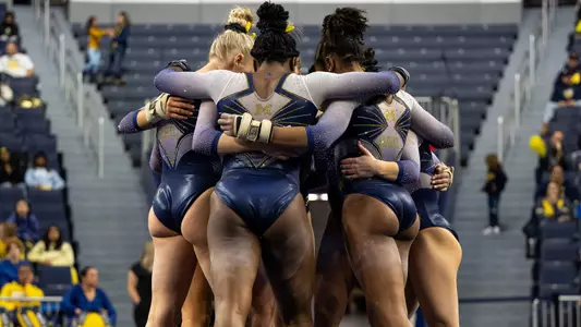 Women's gymnasts team huddle
