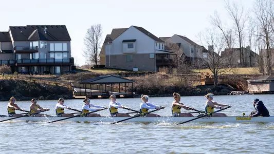 Rowing Eight Boat Passing Homes