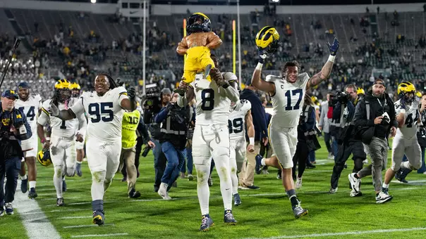 Football Celebrating With Paul Bunyan Trophy