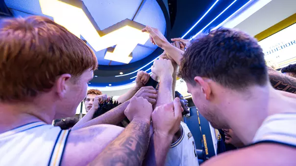 Men's Basketball Team Huddle