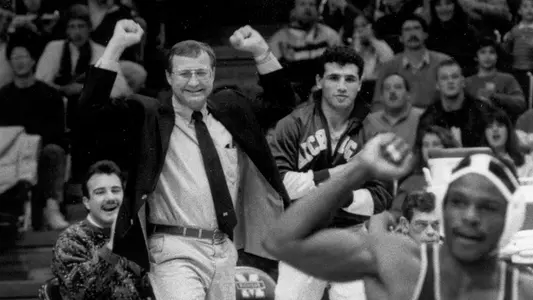 Dale Bahr, left, and Mike Amine cheer on John Fisher during a Michigan dual win in 1988