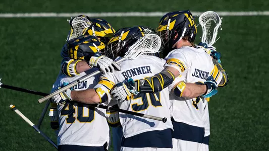 Michigan Men's lacrosse huddle after goal