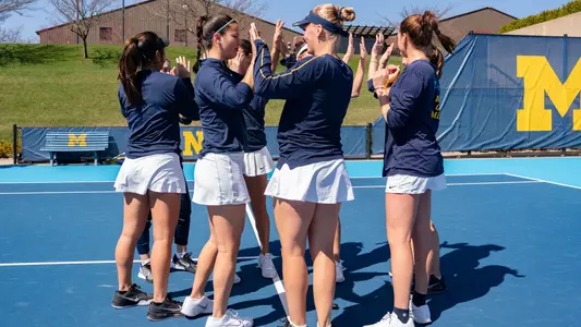 Women's tennis outdoors team huddle pre-match