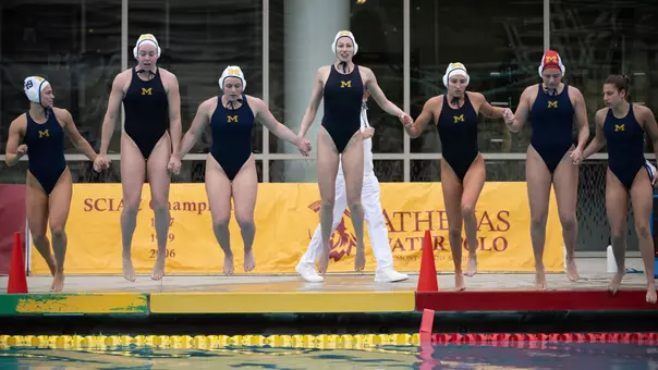 Water polo team jumping into pool