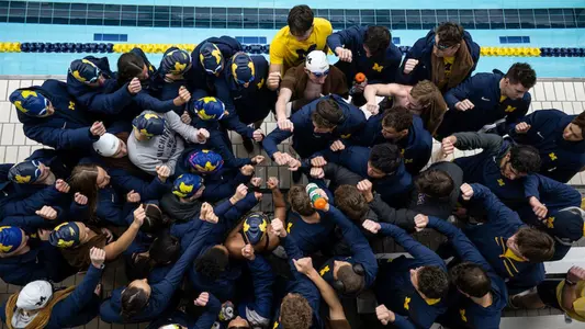Men's and Women's Swimming and Diving Teams Huddle