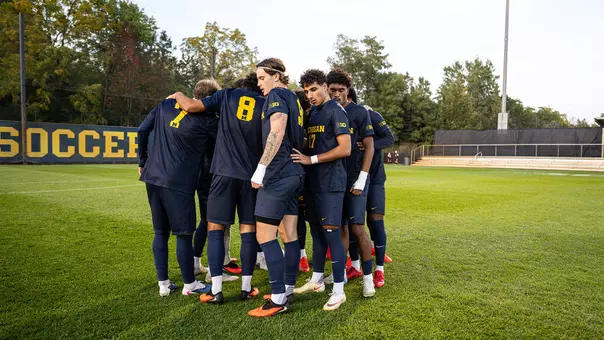 Men's soccer team huddle