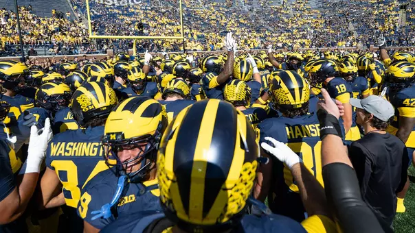Football Team Huddle vs. Penn State