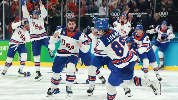 Dylan Larkin (#21 center) and players of Team United States celebrate a 2-1 victory against Canada in overtime for the gold medal during the Men's Gold Medal match between Canada and the United States on day 16 of the Milano Cortina 2026 Winter Olympic games at Milano Santagiulia Ice Hockey Arena on February 22, 2026 in Milan, Italy (Getty Images)