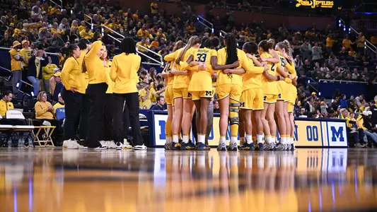 Women's basketball team huddle on court