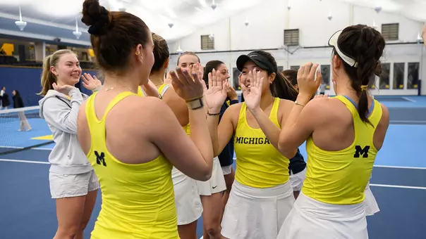 Women's tennis team celebration on-court