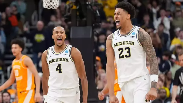 Michigan guard Nimari Burnett (4) and forward Yaxel Lendeborg (23) celebrate during a NCAA Tournament Elite 8 game against Tennessee at the United Center in Chicago on March 29, 2026 (Imagn Images)