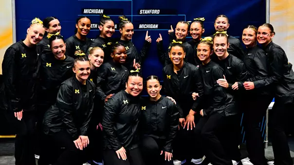 Women's Gymnastics Poses in Front of Regional Bracket