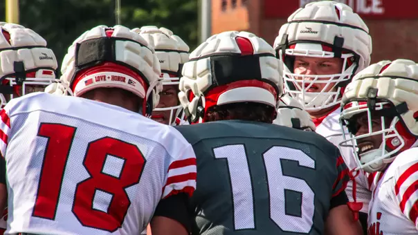 Miami football huddle