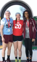 Emily Butters, Lily Johnson and Lynsey Wright in front of the Olympic rings