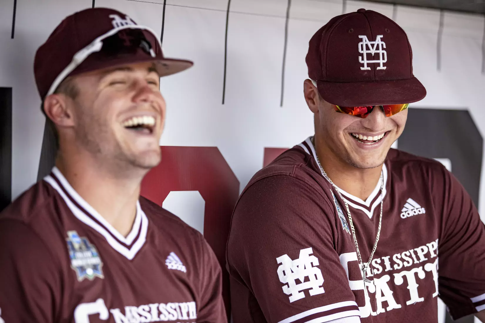 OMAHA, NE - June 22, 2021 - Mississippi State Outfielder Tanner Allen (#5) and Outfielder Brad Cumbest (#33) laugh in the dugout before the 2021 Mens College World Series game between the Mississippi State Bulldogs and the Virginia Cavaliers at TD Ameritrade Park in Omaha, NE. Photo By Austin Perryman