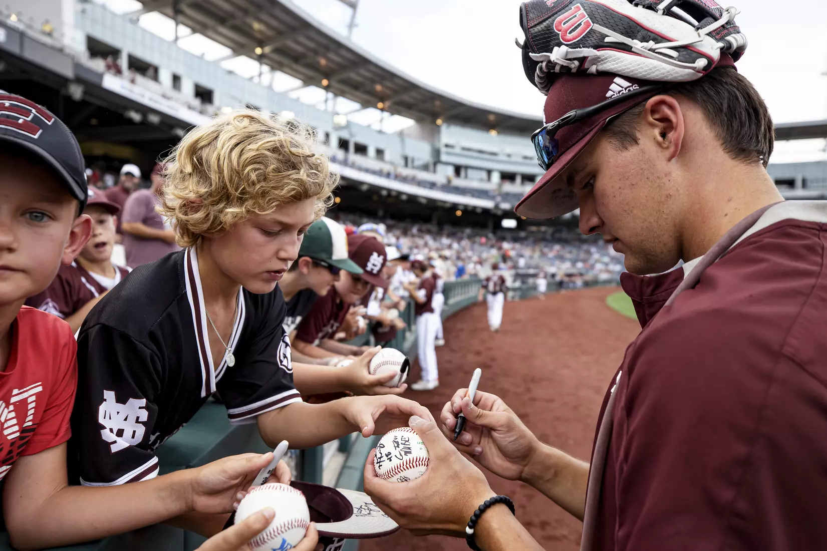 OMAHA, NE - June 22, 2021 - Mississippi State Pitcher Will Bednar (#24) signs autographs before the 2021 Mens College World Series game between the Mississippi State Bulldogs and the Virginia Cavaliers at TD Ameritrade Park in Omaha, NE. Photo By Austin Perryman