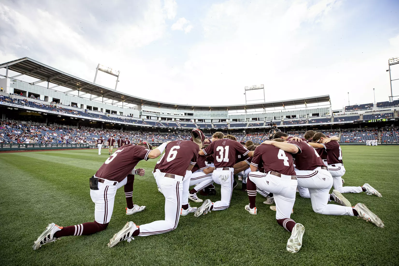 OMAHA, NE - June 22, 2021 - The Mississippi State Bulldogs pray before the 2021 Mens College World Series game between the Mississippi State Bulldogs and the Virginia Cavaliers at TD Ameritrade Park in Omaha, NE. Photo By Austin Perryman