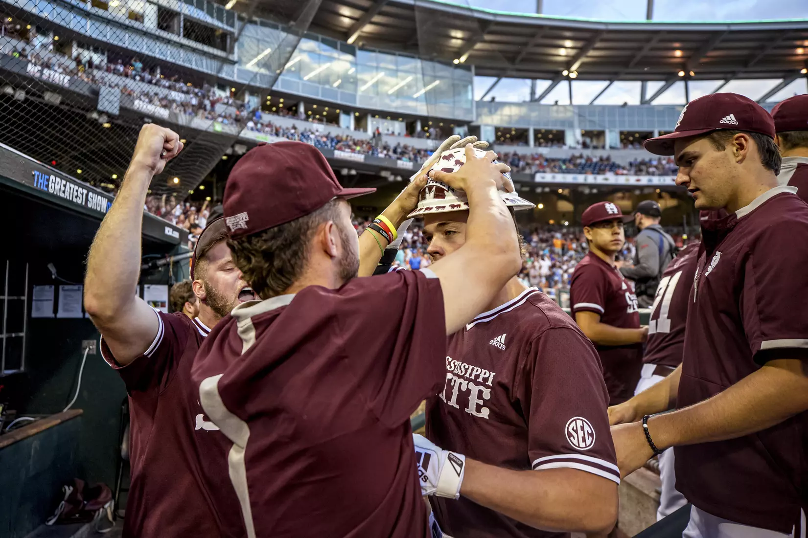OMAHA, NE - June 22, 2021 - Mississippi State Outfielder Kellum Clark (#11) celebrates in the dugout after hitting a home run during the 2021 Mens College World Series game between the Mississippi State Bulldogs and the Virginia Cavaliers at TD Ameritrade Park in Omaha, NE. Photo By Austin Perryman