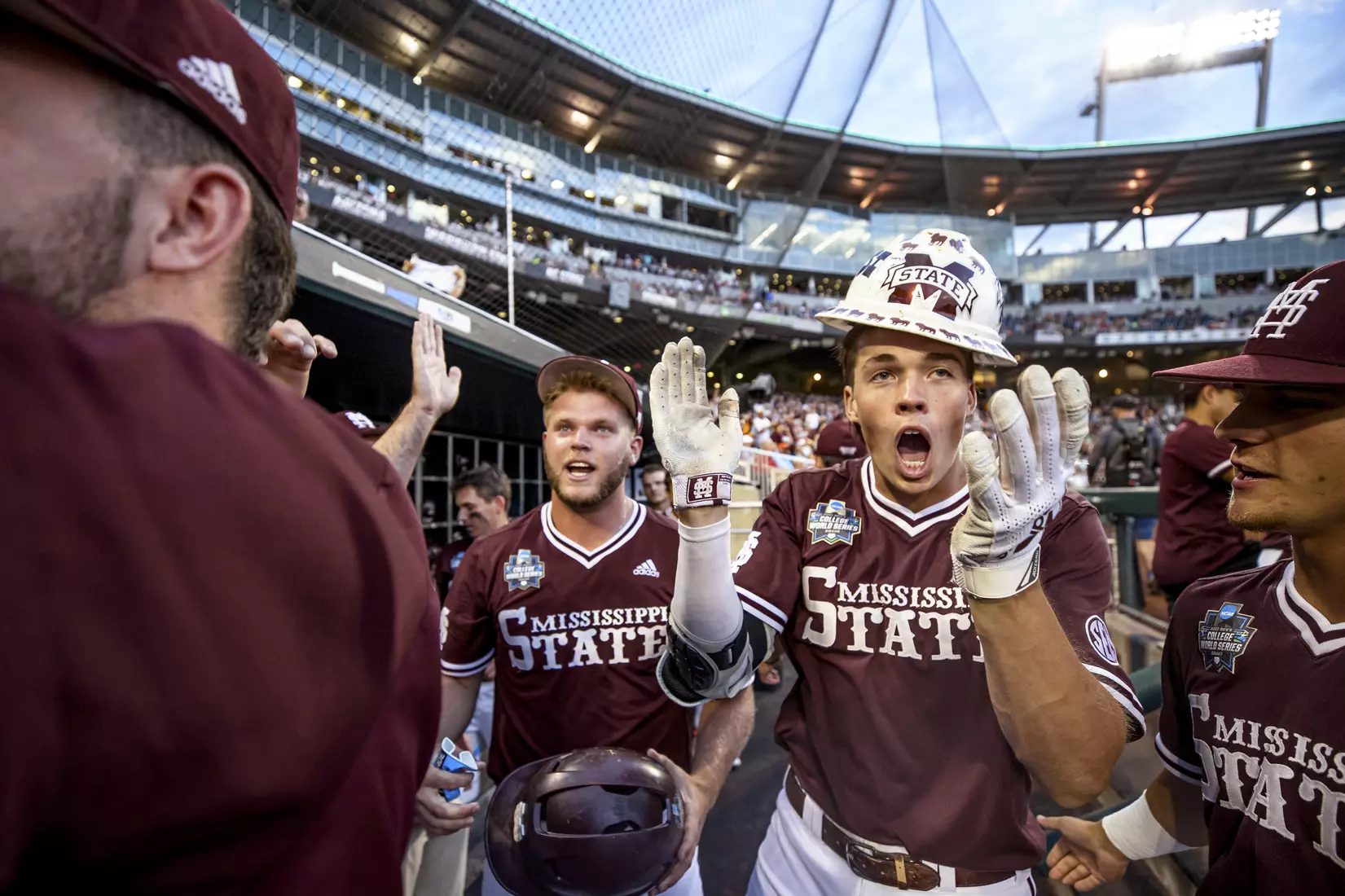 OMAHA, NE - June 22, 2021 - Mississippi State Outfielder Kellum Clark (#11) celebrates in the dugout after hitting a home run during the 2021 Mens College World Series game between the Mississippi State Bulldogs and the Virginia Cavaliers at TD Ameritrade Park in Omaha, NE. Photo By Austin Perryman