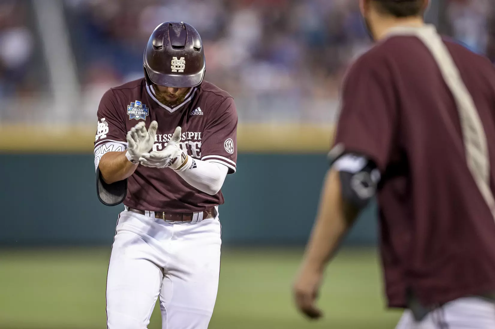 OMAHA, NE - June 22, 2021 - Mississippi State Infielder Luke Hancock (#20) celebrates during the 2021 Mens College World Series game between the Mississippi State Bulldogs and the Virginia Cavaliers at TD Ameritrade Park in Omaha, NE. Photo By Austin Perryman