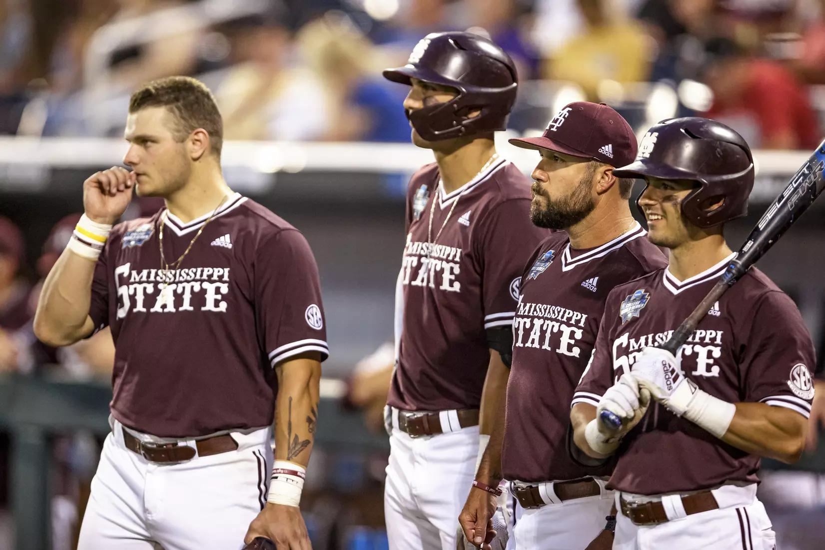 OMAHA, NE - June 22, 2021 - Mississippi State Catcher Logan Tanner (#19), Outfielder Brad Cumbest (#33), Assistant Coach Jake Gautreau, and Infielder Scotty Dubrule (#3) during the 2021 Mens College World Series game between the Mississippi State Bulldogs and the Virginia Cavaliers at TD Ameritrade Park in Omaha, NE. Photo By Austin Perryman
