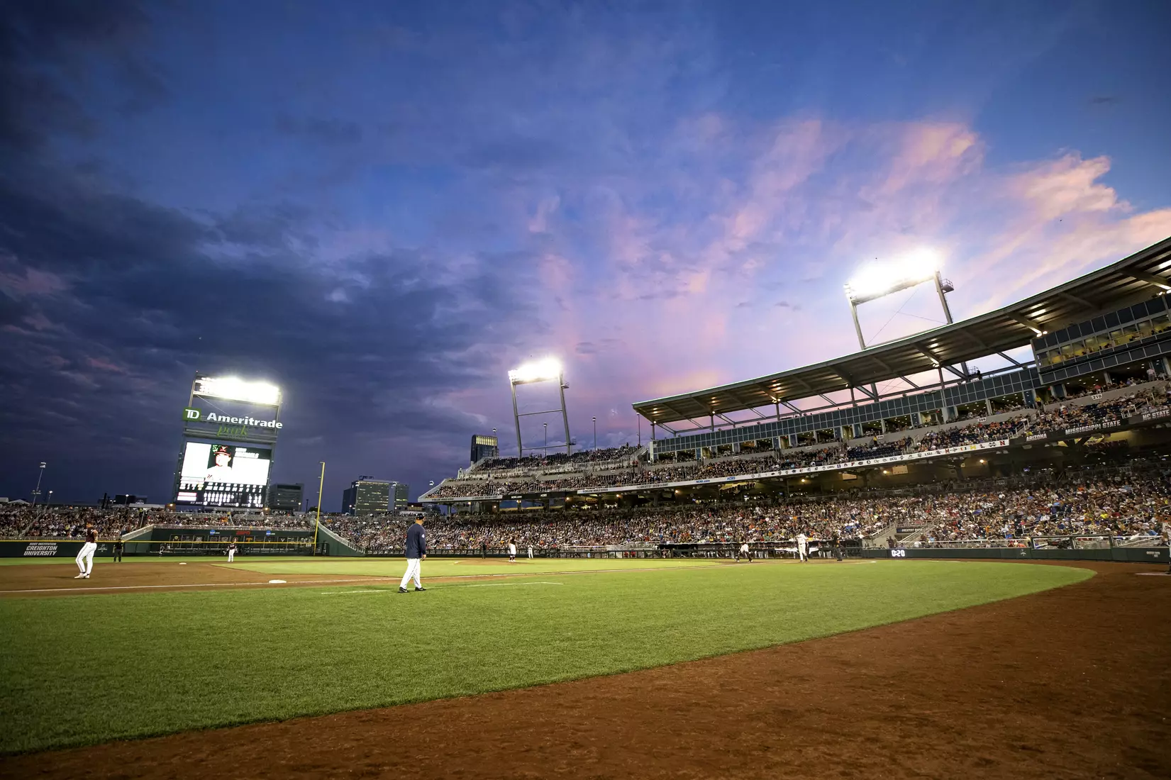OMAHA, NE - June 22, 2021 - Wide shot of the sunset during the 2021 Mens College World Series game between the Mississippi State Bulldogs and the Virginia Cavaliers at TD Ameritrade Park in Omaha, NE. Photo By Austin Perryman