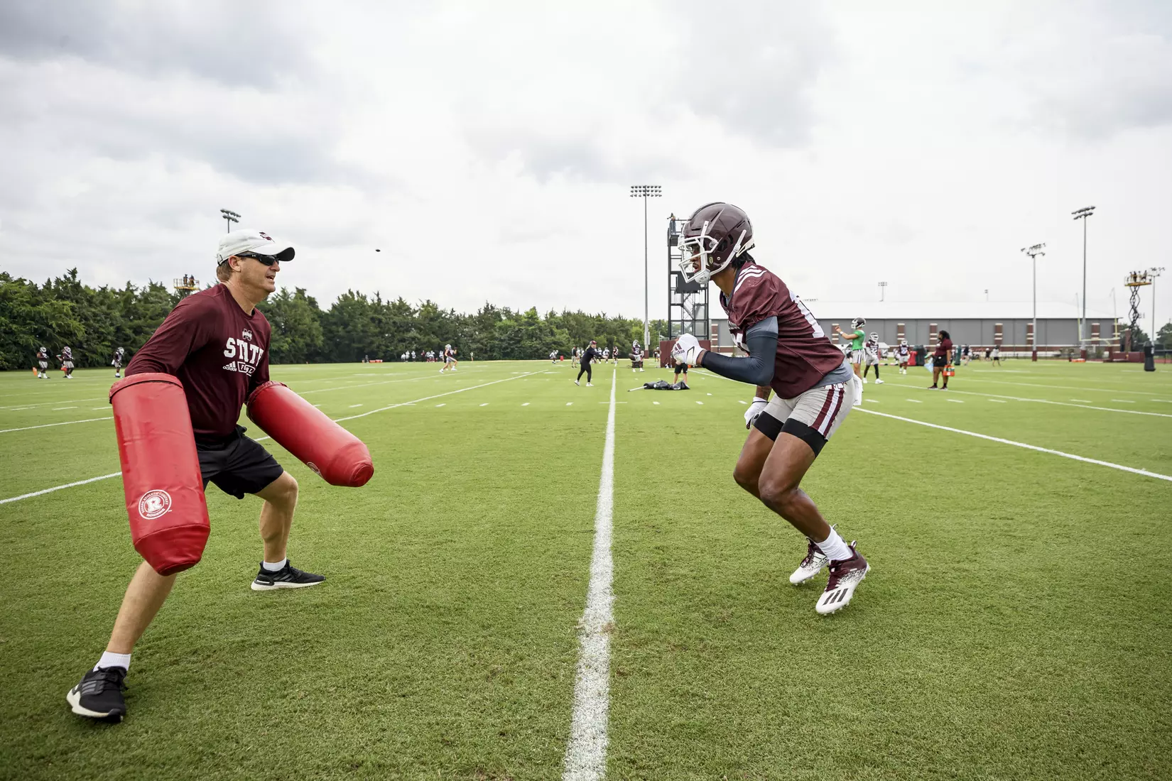 STARKVILLE, MS - August 06, 2021 - Mississippi State Outside Receivers Coach Steve Spurrier Jr and Wide Receiver Makai Polk (#10) during a training camp practice at the Leo Seal Jr. Football Complex at Mississippi State University in Starkville, MS. Photo By Austin Perryman