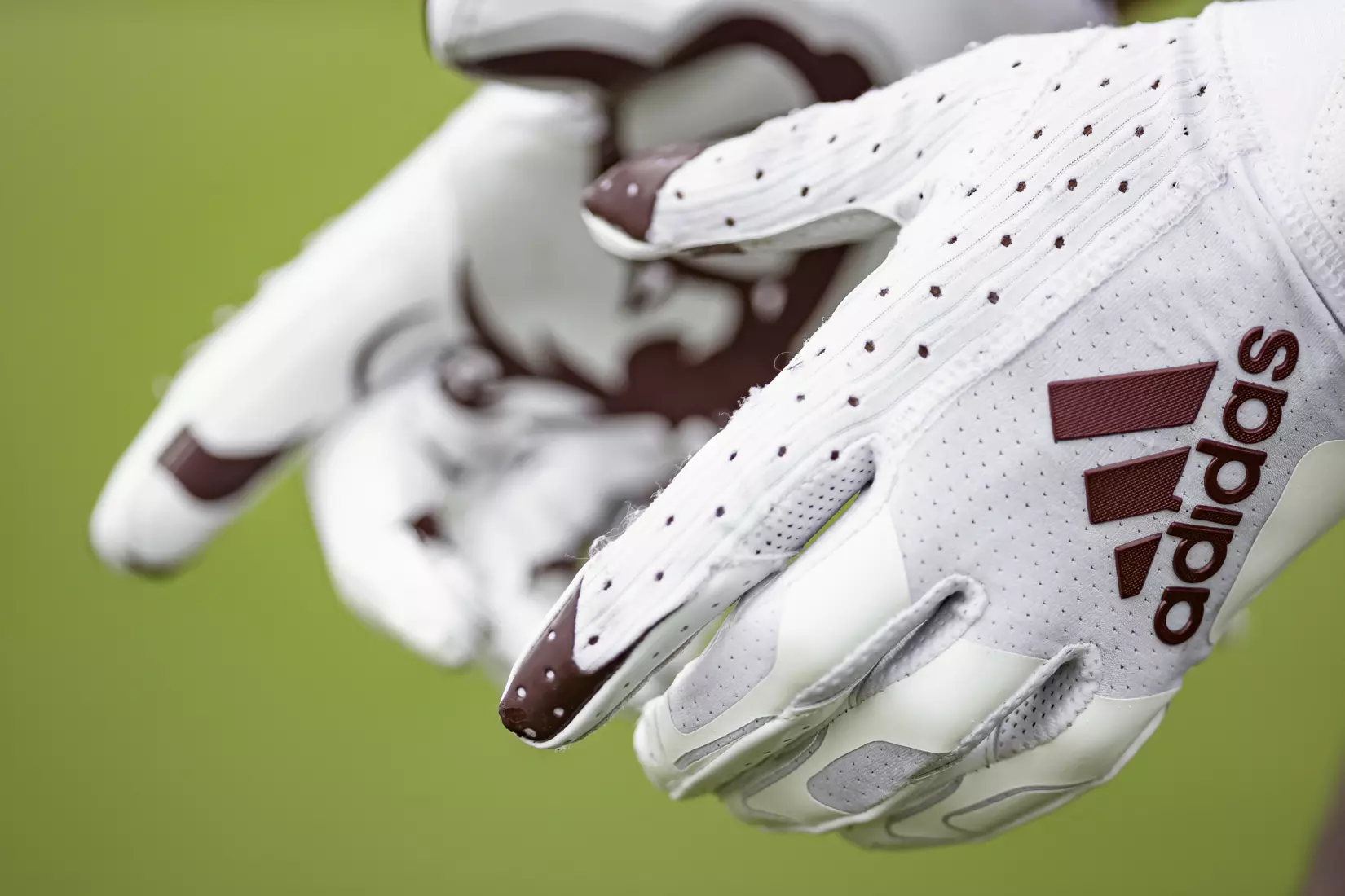 STARKVILLE, MS - August 06, 2021 - Adidas logo football gloves during a training camp practice at the Leo Seal Jr. Football Complex at Mississippi State University in Starkville, MS. Photo By Austin Perryman