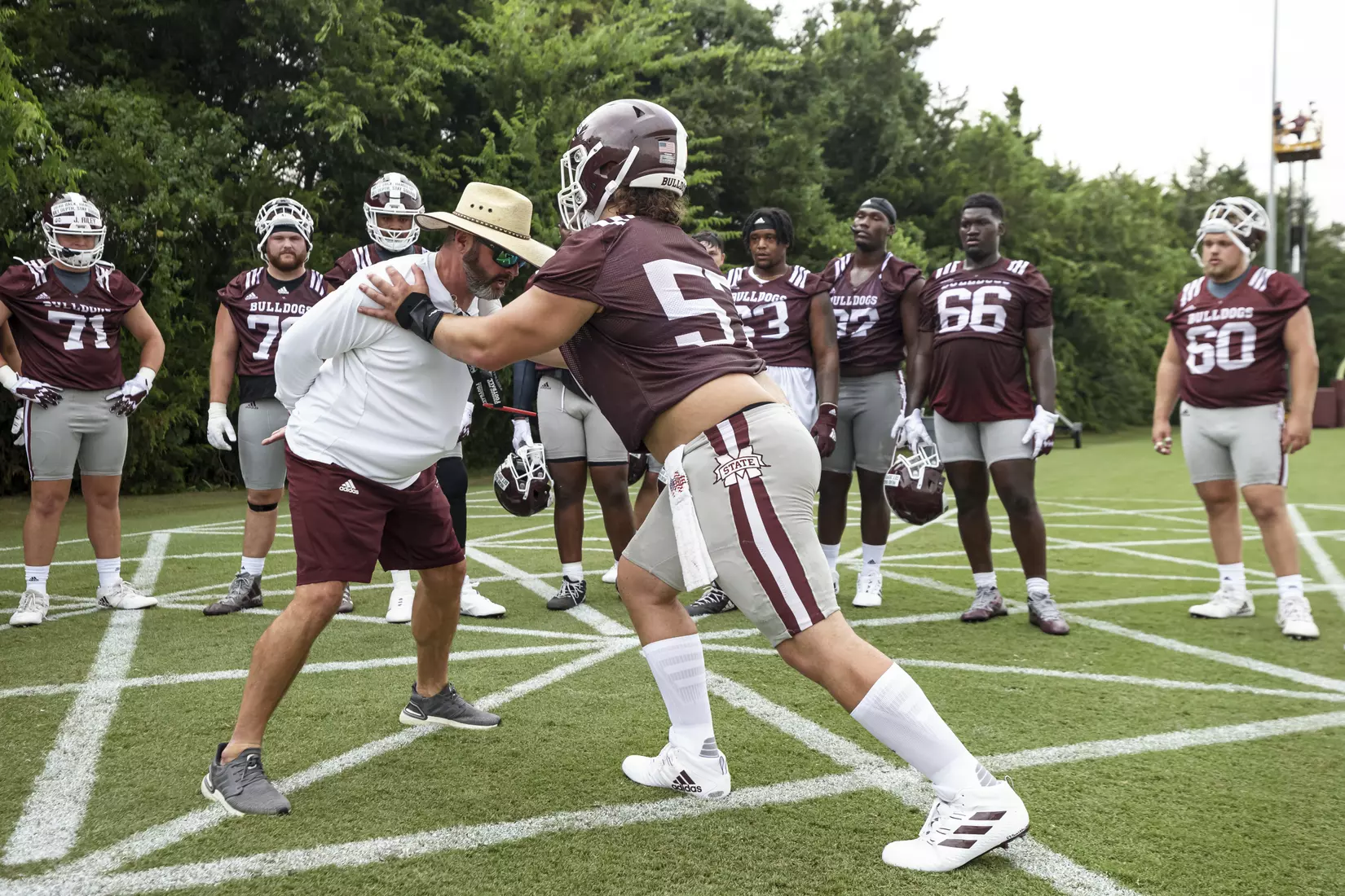STARKVILLE, MS - August 06, 2021 - Mississippi State Offensive Line Coach Mason Miller and Offensive Lineman Cole Smith (#57) during a training camp practice at the Leo Seal Jr. Football Complex at Mississippi State University in Starkville, MS. Photo By Austin Perryman