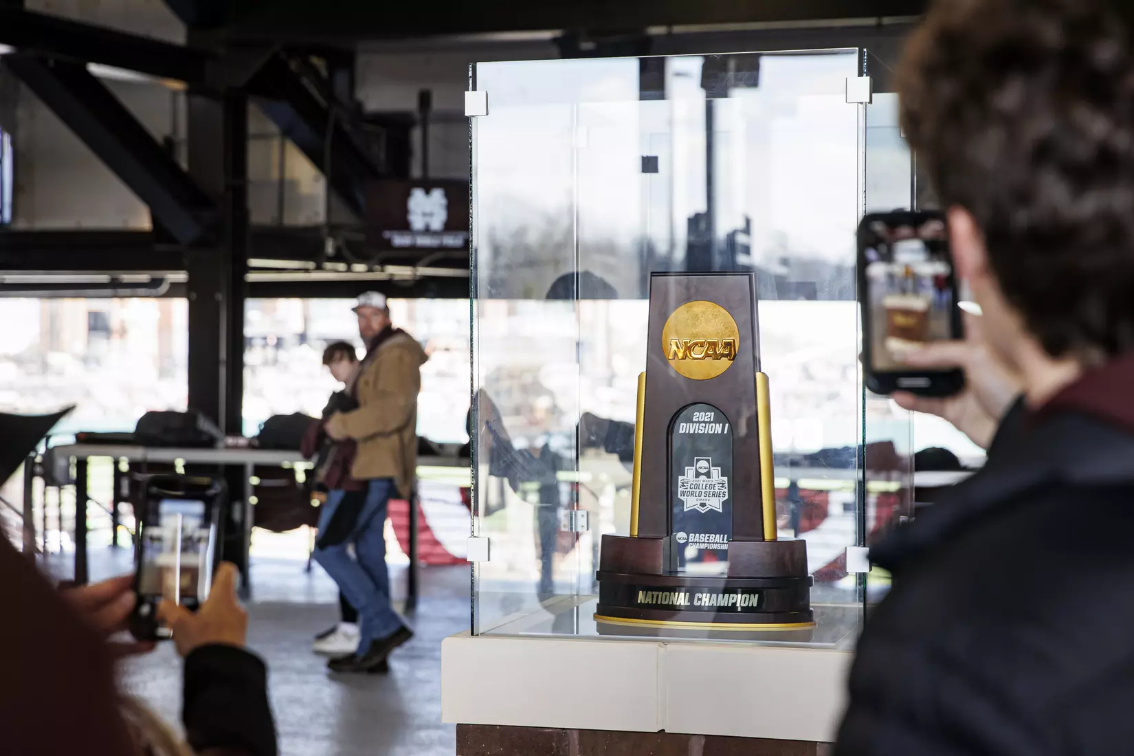 STARKVILLE, MS - February 18, 2022 - Fans take photos of the 2021 College Baseball National Championship Trophy before the game between the Long Beach State Dirtbags and the Mississippi State Bulldogs at Dudy Noble Field at Polk-Dement Stadium in Starkville, MS. Photo By Austin Perryman