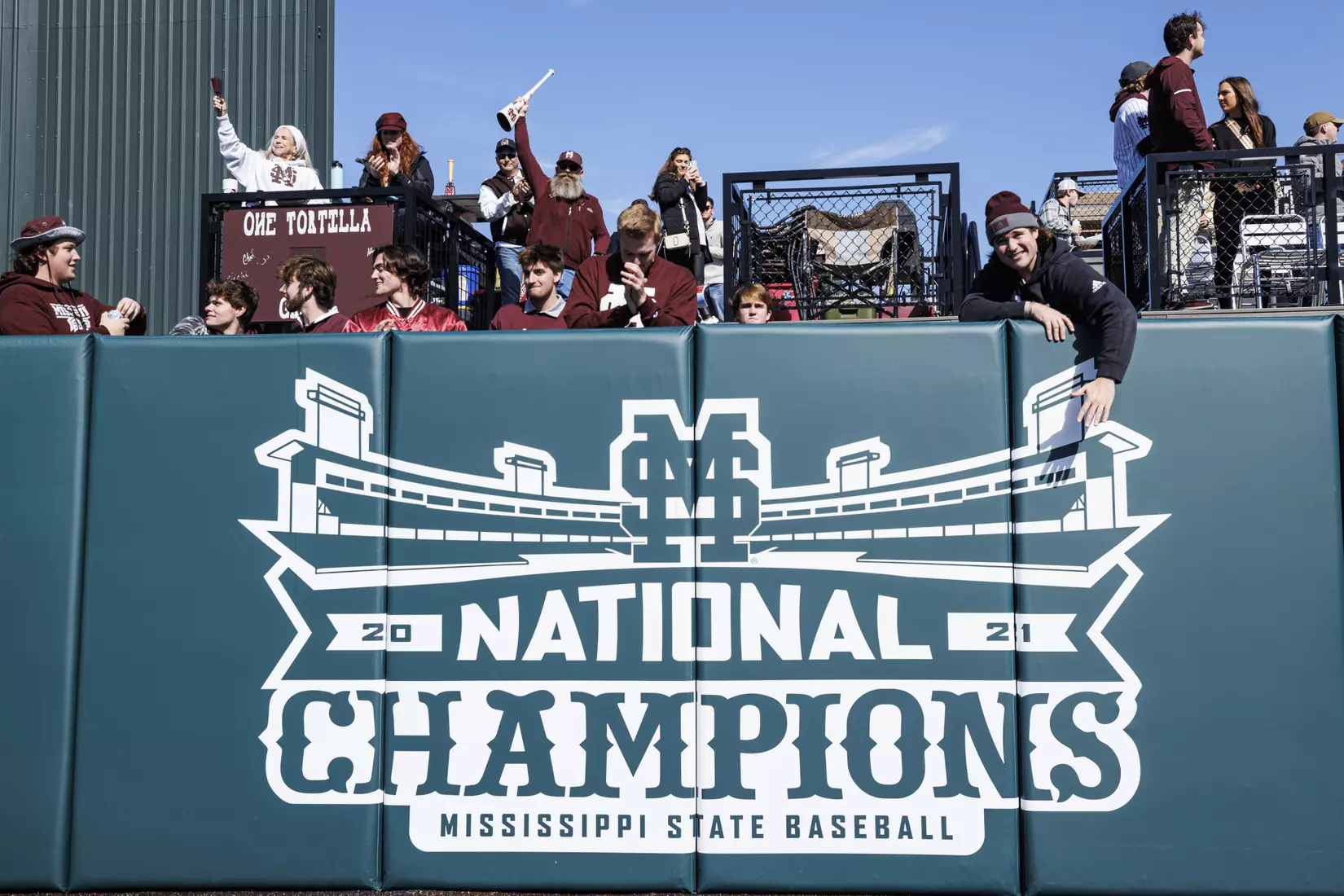 STARKVILLE, MS - February 18, 2022 - Former Mississippi State Pitchers Houston Harding (#48) and Christian MacLeod (#28) unveil the National Championship signage on the centerfield fence before the game between the Long Beach State Dirtbags and the Mississippi State Bulldogs at Dudy Noble Field at Polk-Dement Stadium in Starkville, MS. Photo By Kevin Snyder