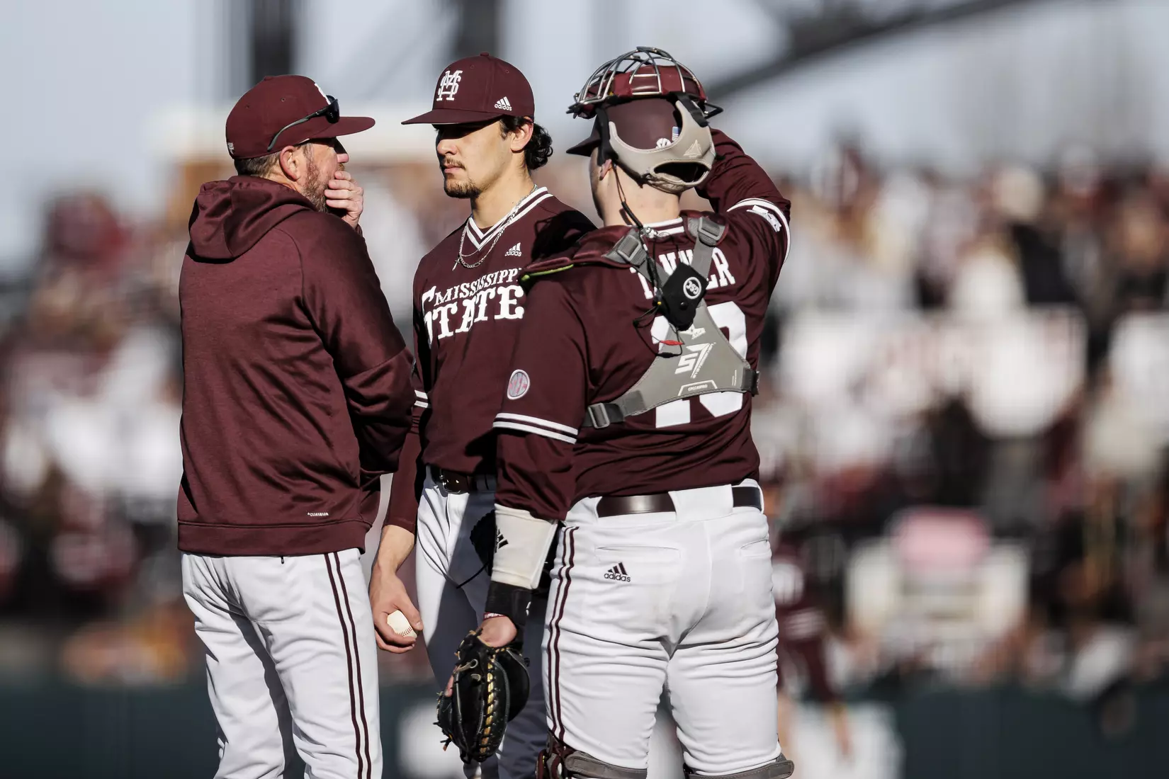 STARKVILLE, MS - February 18, 2022 - Mississippi State Assistant Coach Scott Foxhall, Pitcher Parker Stinnett (#32), and Catcher Logan Tanner (#19) during the game between the Long Beach State Dirtbags and the Mississippi State Bulldogs at Dudy Noble Field at Polk-Dement Stadium in Starkville, MS. Photo By Austin Perryman