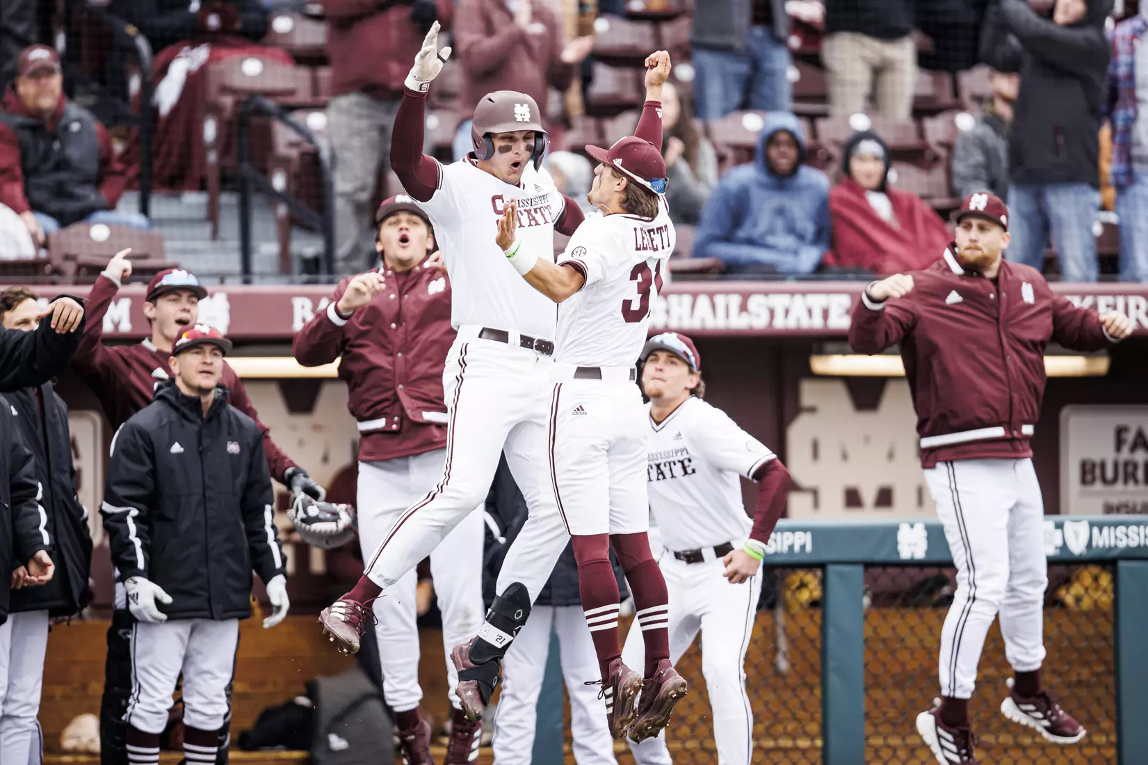 STARKVILLE, MS - February 26, 2022 - Mississippi State Outfielder Brad Cumbest (#33) and Mississippi State Infielder Tanner Leggett (#31) celebrate a home run by Cumbest during the game between the Northern Kentucky Norse and the Mississippi State Bulldogs at Dudy Noble Field at Polk-Dement Stadium in Starkville, MS. Photo By Kevin Snyder