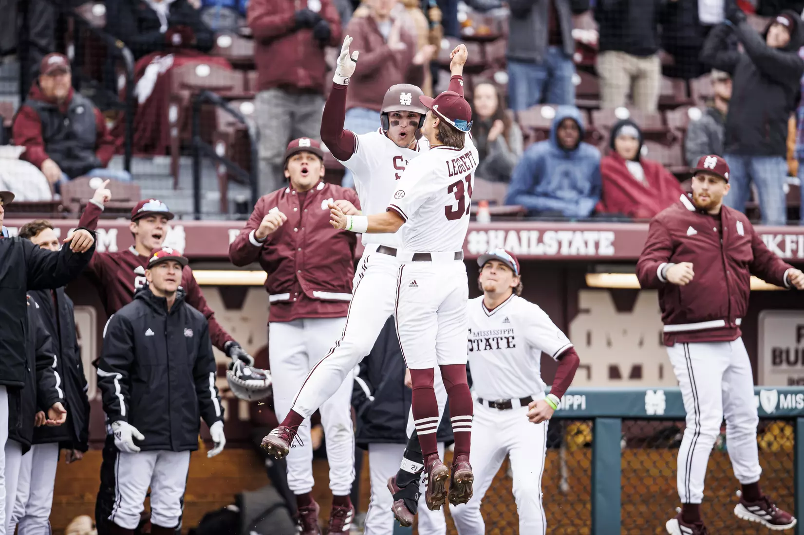 STARKVILLE, MS - February 26, 2022 - Mississippi State Outfielder Brad Cumbest (#33) and Mississippi State Infielder Tanner Leggett (#31) celebrate a home run by Cumbest during the game between the Northern Kentucky Norse and the Mississippi State Bulldogs at Dudy Noble Field at Polk-Dement Stadium in Starkville, MS. Photo By Kevin Snyder