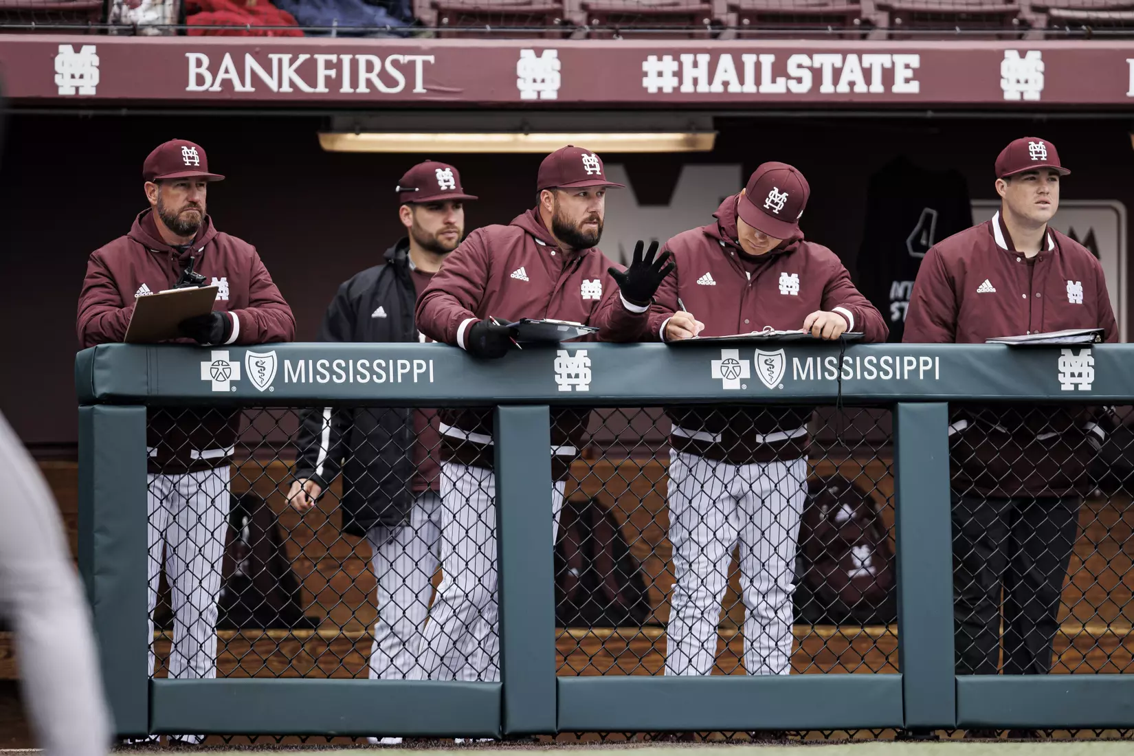 STARKVILLE, MS - February 27, 2022 - Mississippi State Assistant Coach Scott Foxhall, Assistant Coach Jake Gautreau, and Coordinator of Baseball Player Development Bobby Austin in the dugout during the game between the Northern Kentucky Norse and the Mississippi State Bulldogs at Dudy Noble Field at Polk-Dement Stadium in Starkville, MS. Photo By Austin Perryman