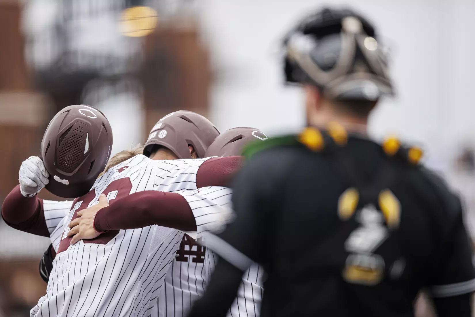 STARKVILLE, MS - February 27, 2022 - Mississippi State Infielder/Outfielder Aaron Downs (#5), Outfielder Brad Cumbest (#33), and Catcher Logan Tanner (#19) hug during the game between the Northern Kentucky Norse and the Mississippi State Bulldogs at Dudy Noble Field at Polk-Dement Stadium in Starkville, MS. Photo By Austin Perryman