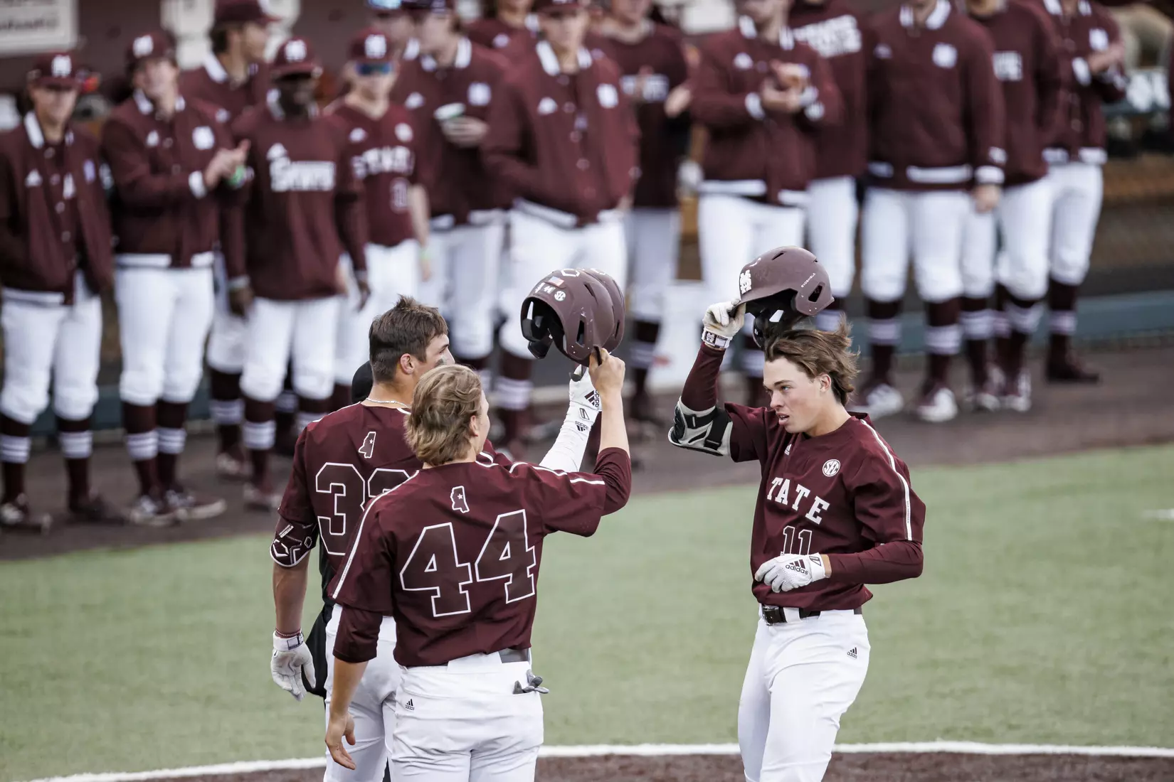 STARKVILLE, MS - March 23, 2022 - Mississippi State Outfielder Brad Cumbest (#33), Infielder/Outfielder Hunter Hines (#44), and Outfielder Kellum Clark (#11) celebrate during the game between the Southern Jaguars and the Mississippi State Bulldogs at Dudy Noble Field at Polk-Dement Stadium in Starkville, MS. Photo By Austin Perryman