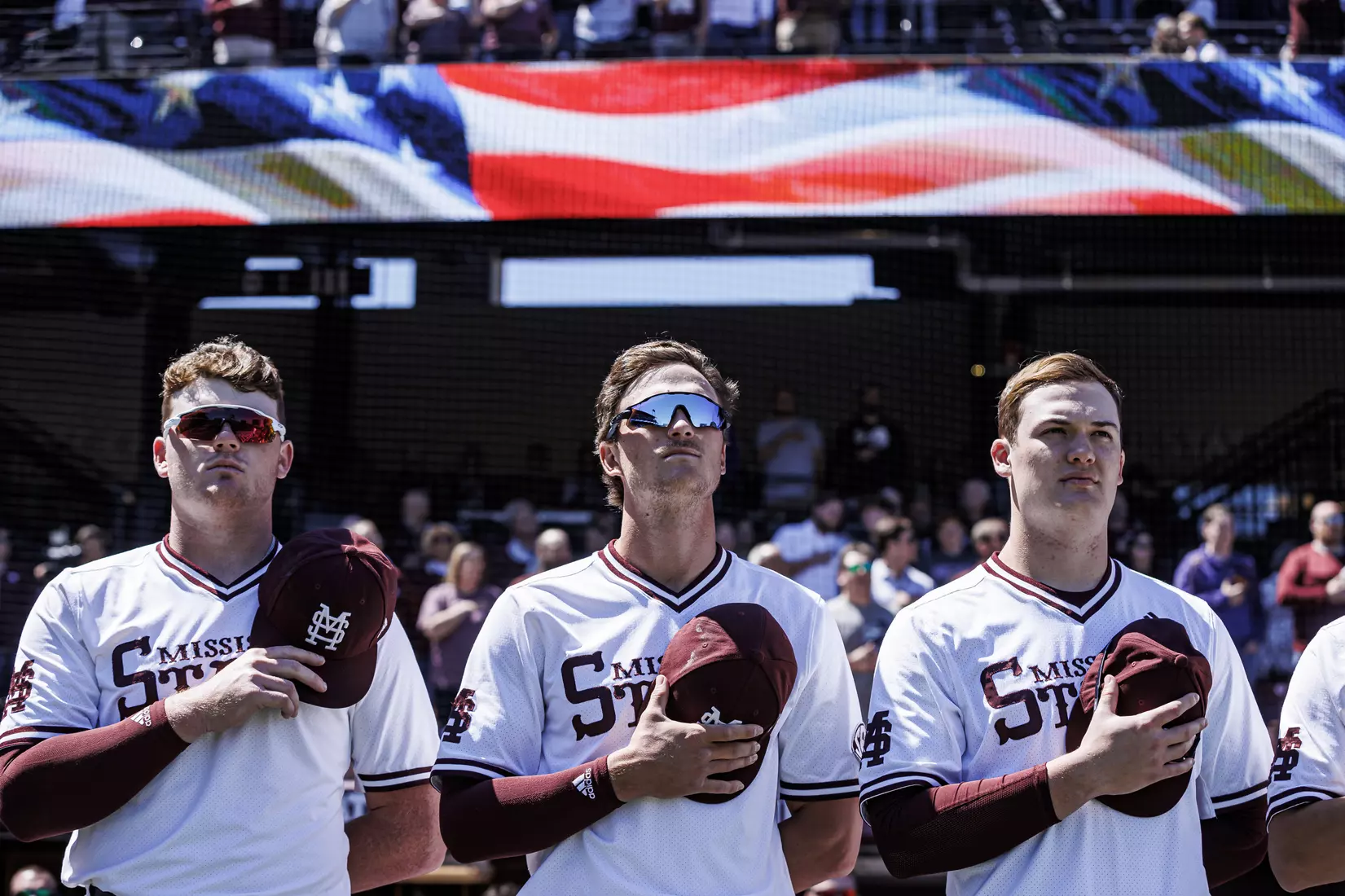 STARKVILLE, MS - April 09, 2022 - Mississippi State Infielder RJ Yeager (#4), Mississippi State Infielder/Outfielder Von Seibert (#30), and Mississippi State Outfielder Revy Higgins III (#10) during the national anthem before the game between the LSU Tigers and the Mississippi State Bulldogs at Dudy Noble Field at Polk-Dement Stadium in Starkville, MS. Photo By Mississippi State Athletics