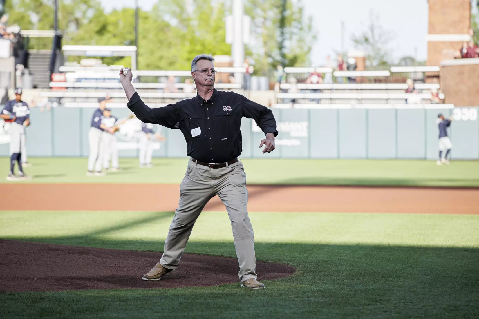 STARKVILLE, MS - April 19, 2022 - Joe Shumaker, on behalf of the Risk Management and Insurance Program in the College of Business, throws out the ceremonial first pitch before the game between the Jackson State Tigers and the Mississippi State Bulldogs at Dudy Noble Field at Polk-Dement Stadium in Starkville, MS. Photo By Kevin Snyder