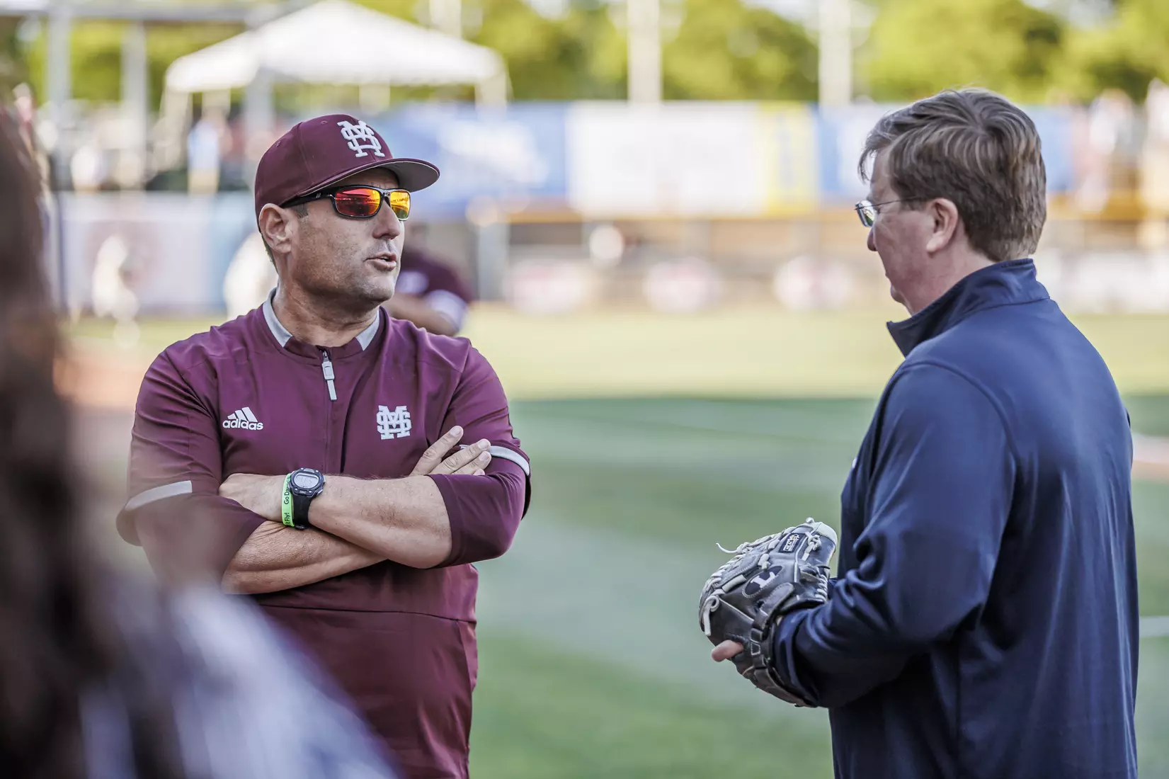 STARKVILLE, MS - April 26, 2022 - Mississippi State Head Coach Chris Lemonis talks with Mississippi Governor Tate Reeves before the game between the Mississippi State Bulldogs and the Ole Miss Rebels at Trustmark Park in Pearl, MS. Photo By Kevin Snyder