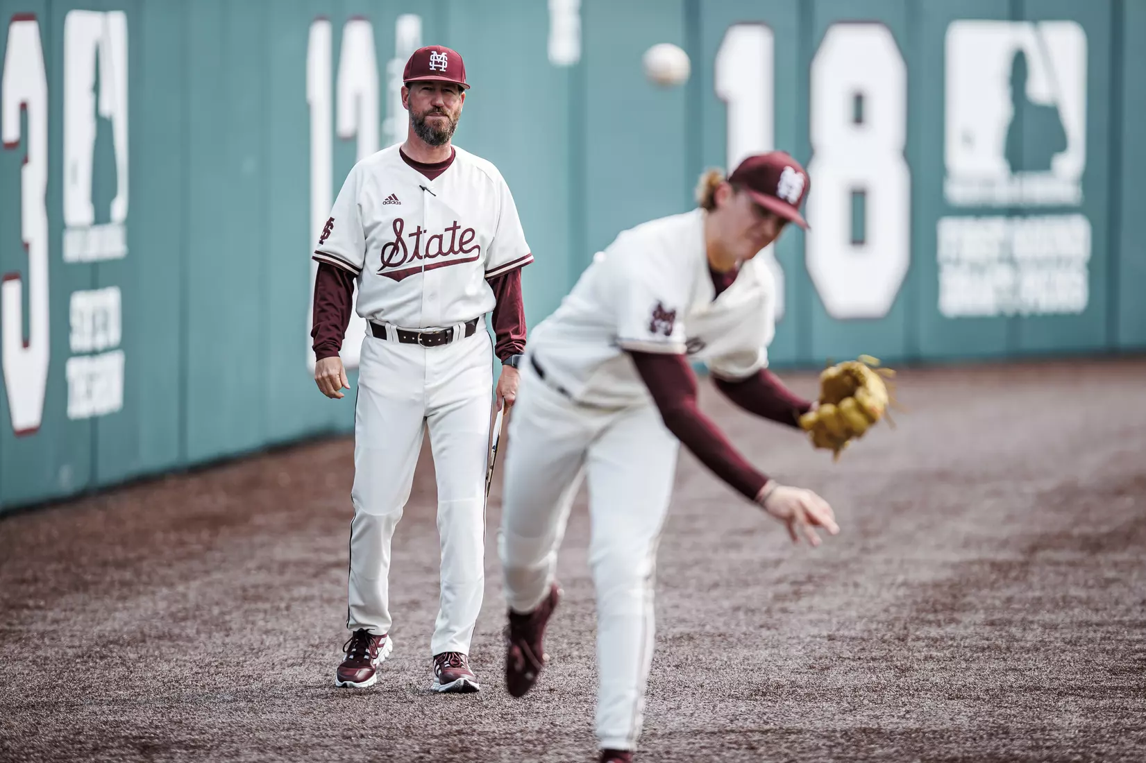 STARKVILLE, MS - February 22, 2022 - Mississippi State Assistant Coach Scott Foxhall and Pitcher Jackson Fristoe (#27) before the game between the University of Arkansas at Pine Bluff Golden Lions and the Mississippi State Bulldogs at Dudy Noble Field at Polk-Dement Stadium in Starkville, MS. Photo By Kevin Snyder