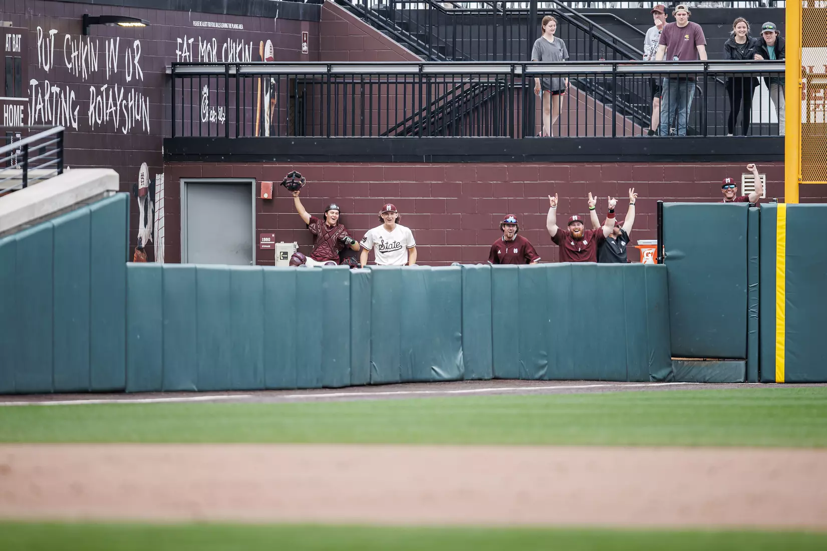 STARKVILLE, MS - February 22, 2022 - Mississippi State Pitcher Pico Kohn (#9) and Mississippi State Student Manager Gavin Schmidt celebrate in the bullpen during the game between the University of Arkansas at Pine Bluff Golden Lions and the Mississippi State Bulldogs at Dudy Noble Field at Polk-Dement Stadium in Starkville, MS. Photo By Kevin Snyder