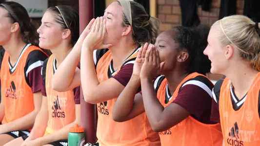 Jamila Coner cheers on her teammates from the dugout.