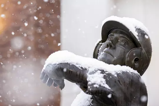 STARKVILLE, MS - January 11, 2021 - Will Clark statue outside Dudy Noble Field at Polk Dement Stadium during a snow day at Mississippi State University in Starkville, MS. Photo By Austin Perryman