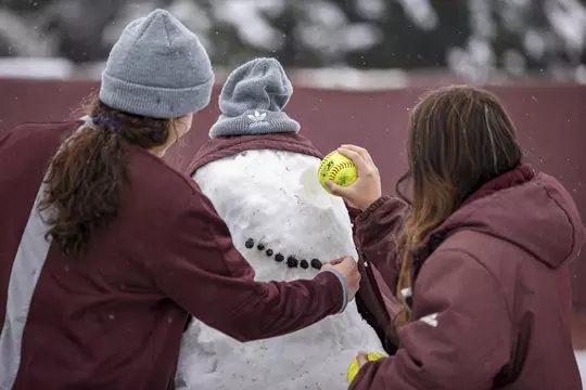 STARKVILLE, MS - January 11, 2021 - Mississippi State Infielder Madisyn Kennedy (#18) and Pitcher Aspen Wesley (#28) build a snowman at Nusz Park during a snow day at Mississippi State University in Starkville, MS. Photo By Austin Perryman