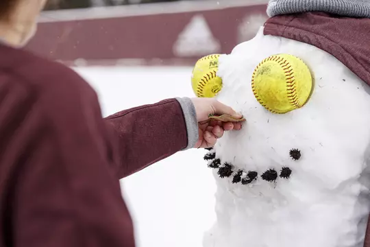 STARKVILLE, MS - January 11, 2021 - Mississippi State Infielder Madisyn Kennedy (#18) and Pitcher Aspen Wesley (#28) build a snowman at Nusz Park during a snow day at Mississippi State University in Starkville, MS. Photo By Austin Perryman