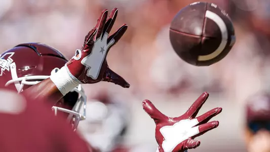 STARKVILLE, MS - October 01, 2022 - Hands catching a football before the game between the Texas A&M Aggies and the Mississippi State Bulldogs at Davis Wade Stadium at Scott Field in Starkville, MS. Photo By Kevin Snyder
