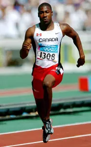 Canadian sprinter Pierre Brown of Toronto, Ontario, runs during the 100m heat during the Athens 2004 Summer Olympic Games Saturday, August 21, 2004. Brown crossed the line with a time of 10.32 to move on. (CP PHOTO/COC-Andre Forget) Le sprinter canadien Pierre Browne de Toronto, Ontario, court lors de la ronde de qualification au 100 m aux Jeux olympiques d'été à Athènes le samedi 21 août 2004. Browne a franchi la ligne d'arrivée avec un chrono de 10.32 qui lui permet d'avancer.