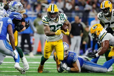 Green Bay Packers running back Kylin Hill (32) runs against Detroit Lions defensive end John Cominsky (79) during the second half at Ford Field in Detroit on Sunday, Nov. 6, 2022.Nfl Green Bay Packers At Detroit Lions