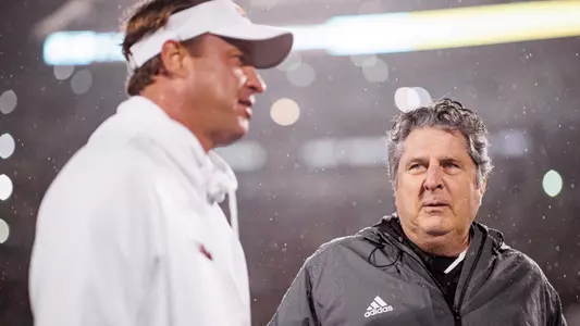 STARKVILLE, MS - November 25, 2021 - Mississippi State Head Coach Mike Leach speaks with Ole Miss Head Coach Lane Kiffin before the Egg Bowl game between the Ole Miss Rebels and the Mississippi State Bulldogs at Davis Wade Stadium at Scott Field in Starkville, MS. Photo By Austin Perryman